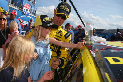 LOUDON, NH - JULY 17: Matt Kenseth, driver of the #20 Dollar General Toyota, places the winner's decal on his car with the help of his daughters Clara, Kaylin and Grace after winning the NASCAR Sprint Cup Series New Hampshire 301 at New Hampshire Motor Speedway on July 17, 2016 in Loudon, New Hampshire. (Photo by Sarah Crabill/NASCAR via Getty Images)