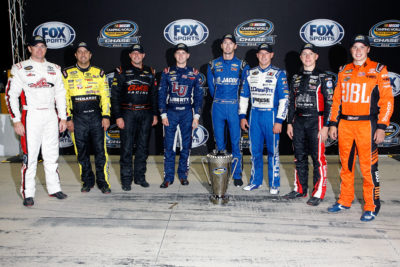 JOLIET, IL - SEPTEMBER 16: (L-R)Timothy Peters, driver of the #17 Red Horse Racing Toyota, Matt Crafton, driver of the #88 Fisher Nuts/Menards Toyota, Johnny Sauter, driver of the #21 Alamo Chevrolet, William Byron, driver of the #9 Liberty University Toyota, Ben Kennedy, driver of the #33 Weber Chevrolet, Daniel Hemric, driver of the #19 Draw-Tite Ford, John H Nemechek, driver of the #8 TeamTurtle/TeamFoot Chevrolet, and Christopher Bell, driver of the #4 JBL Toyota, pose with the NASCAR Camping World Truck Series trophy after the NASCAR Camping World Truck Series American Ethanol E15 225 at Chicagoland Speedway on September 16, 2016 in Joliet, Illinois. (Photo by Brian Lawdermilk/NASCAR via Getty Images)