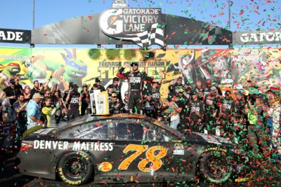 JOLIET, IL - SEPTEMBER 18: Martin Truex Jr, driver of the #78 Furniture Row/Denver Mattress Toyota, celebrates in Victory Lane after winning the NASCAR Sprint Cup Series Teenage Mutant Ninja Turtles 400 at Chicagoland Speedway on September 18, 2016 in Joliet, Illinois. (Photo by Kena Krutsinger/Getty Images)