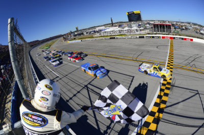 TALLADEGA, AL - OCTOBER 22: Grant Enfinger, driver of the #24 Plugfones Chevrolet, takes the checkered flag to win the NASCAR Camping World Truck Series fred's 250 at Talladega Superspeedway on October 22, 2016 in Talladega, Alabama. (Photo by Robert Laberge/NASCAR via Getty Images)