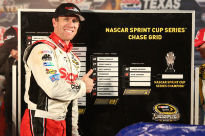 FORT WORTH, TX - NOVEMBER 06: Carl Edwards, driver of the #19 Sport Clips Toyota, points to the Championship Round of the Chase Grid in Victory Lane after winning the rain-shortened NASCAR Sprint Cup Series AAA Texas 500 at Texas Motor Speedway on November 6, 2016 in Fort Worth, Texas. (Photo by Jerry Markland/Getty Images)